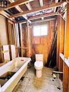 Bathroom featuring toilet and a freestanding bath - 