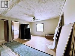 Unfurnished bedroom featuring ceiling fan and light wood-style flooring - 