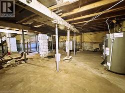 Unfinished basement featuring electric water heater - 