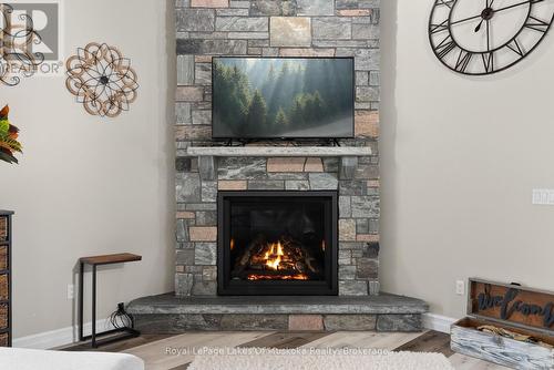 Handmade Granite Fireplace from Manitoulin Island. - 679 Boulder Road, South River, ON - Indoor Photo Showing Living Room With Fireplace