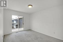 Primary Bedroom w/patio door leading to balcony. - 
