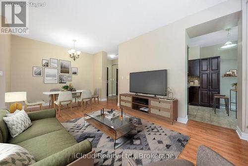 Virtually staged living and dining rooms - 307 - 208 Enfield Place, Mississauga, ON - Indoor Photo Showing Living Room