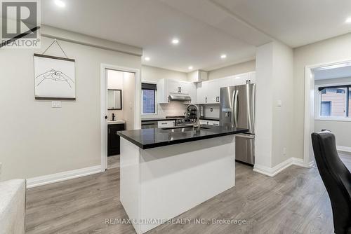 Island doubles as seating for casual meals - 47 Mahoney Avenue, Toronto, ON - Indoor Photo Showing Kitchen