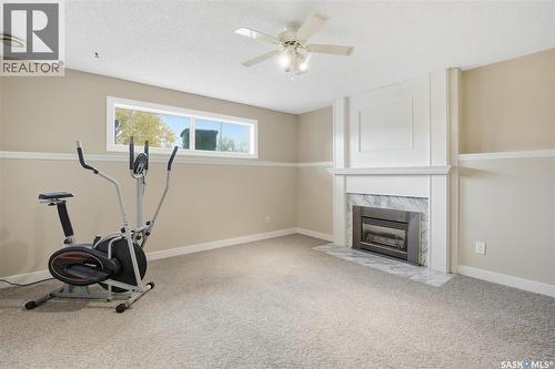 614 Reid Road, Saskatoon, SK - Indoor Photo Showing Gym Room With Fireplace
