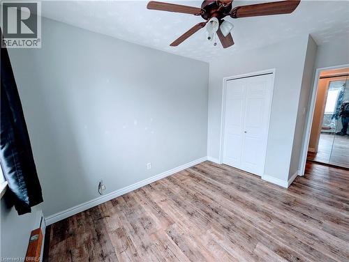 Bedroom 3 featuring light wood-style floors, closet, and ceiling fan - 87 St George Street Unit# 507, Brantford, ON - Indoor Photo Showing Other Room