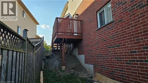 View of property exterior featuring brick siding and stairs - 10 Doll Court Unit# Lower, Kitchener, ON - Outdoor With Exterior
