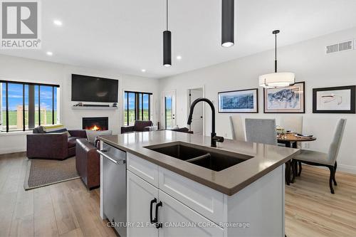 672 Ketter Way, Plympton-Wyoming (Plympton Wyoming), ON - Indoor Photo Showing Kitchen With Fireplace With Double Sink