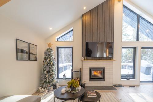 Aerial photo - 215 Ch. Des Chênes, Amherst, QC - Indoor Photo Showing Living Room With Fireplace