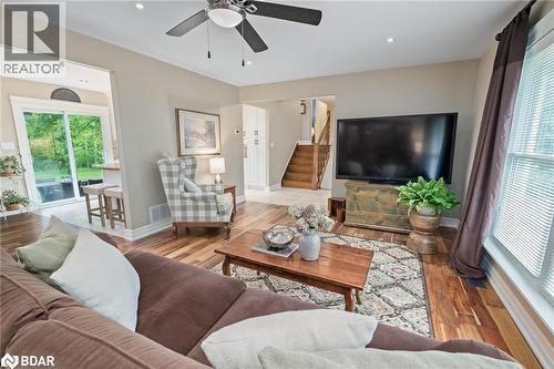 Living area with wood finished floors, stairway, recessed lighting, and a ceiling fan - 13609 Sixth Line, Limehouse, ON - Indoor Photo Showing Living Room