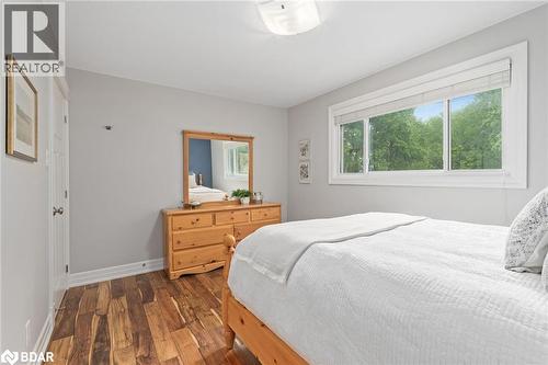 Bedroom with dark wood-type flooring and baseboards - 13609 Sixth Line, Limehouse, ON - Indoor Photo Showing Bedroom