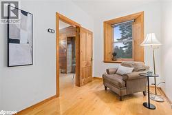 Sitting room with wood finished floors and baseboards - 