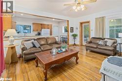Living area featuring light wood-style floors, recessed lighting, and ceiling fan - 