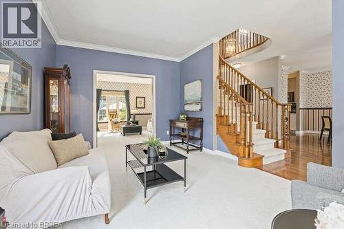 Carpeted living room with stairway and ornamental molding - 119 Parkview Lane, Rockwood, ON - Indoor Photo Showing Living Room