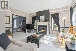 Living room with wallpapered walls and a fireplace - 