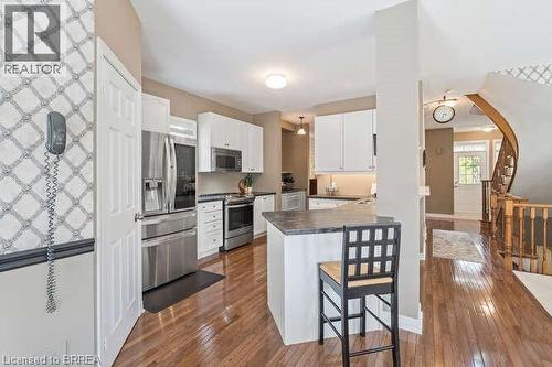 Kitchen featuring a breakfast bar area, white cabinetry, appliances with stainless steel finishes, dark countertops, and a peninsula - 119 Parkview Lane, Rockwood, ON - Indoor Photo Showing Kitchen With Stainless Steel Kitchen With Upgraded Kitchen