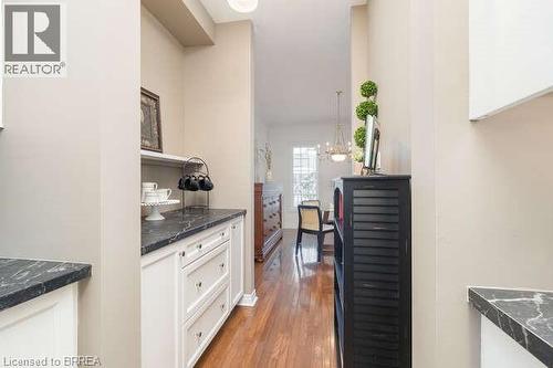 Corridor with dark wood finished floors and a chandelier - 119 Parkview Lane, Rockwood, ON - Indoor