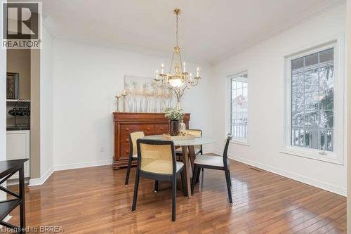 Dining area with wood-type flooring, ornamental molding, and a chandelier - 119 Parkview Lane, Rockwood, ON - Indoor Photo Showing Dining Room