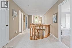 Corridor featuring an upstairs landing and carpet flooring - 