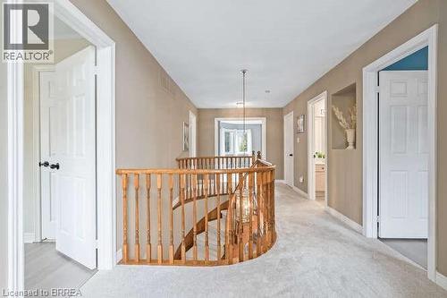 Hall with an upstairs landing, light carpet, and a chandelier - 119 Parkview Lane, Rockwood, ON - Indoor Photo Showing Other Room