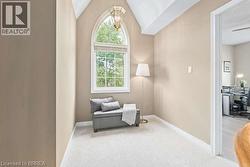 Sitting room featuring vaulted ceiling, carpet, and an office area - 