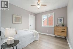 Bedroom with light wood-style flooring and ceiling fan - 