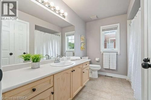 Bathroom with vanity, a shower with shower curtain, and light tile patterned floors - 119 Parkview Lane, Rockwood, ON - Indoor Photo Showing Bathroom