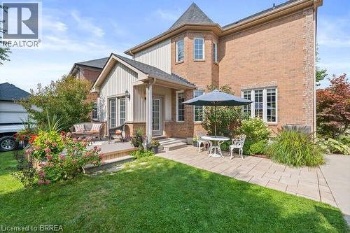Rear view of house with a yard, a patio, brick siding, and a deck - 119 Parkview Lane, Rockwood, ON - Outdoor