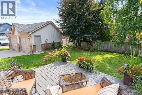 Wooden deck featuring a garage, a fenced backyard, and outdoor lounge area - 119 Parkview Lane, Rockwood, ON - Outdoor With Deck Patio Veranda