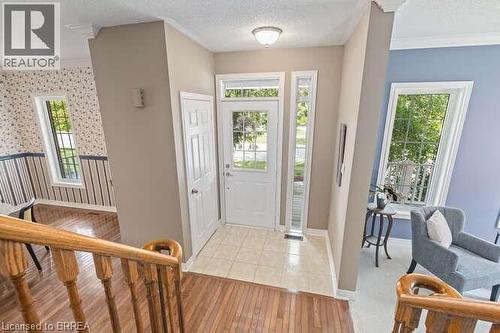 Foyer featuring ornamental molding, light wood finished floors, a wainscoted wall, and a textured ceiling - 119 Parkview Lane, Rockwood, ON - Indoor Photo Showing Other Room