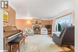 Living area featuring a fireplace and wood finished floors - 