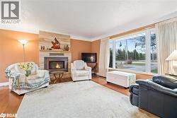 Living area featuring a fireplace and wood finished floors - 