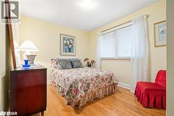 Bedroom featuring light wood-style flooring and baseboards - 