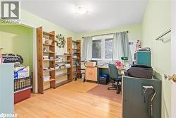 Office with light wood-style flooring - 