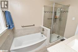 Full bathroom with vanity, a bath, light wood-type flooring, and a stall shower - 