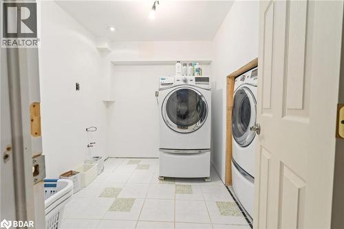 Washroom featuring light tile patterned flooring and independent washer and dryer - 11317 Regional Road 25, Halton Hills, ON - Indoor Photo Showing Laundry Room