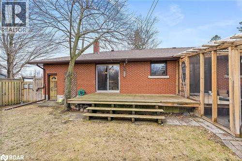 Back of property with a wooden deck, brick siding, a chimney, and a shingled roof - 11317 Regional Road 25, Halton Hills, ON - Outdoor