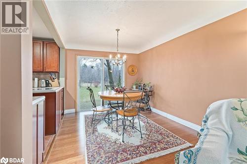 Dining area featuring light wood-style floors and a chandelier - 11317 Regional Road 25, Halton Hills, ON - Indoor Photo Showing Dining Room