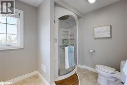 Full bath with a stall shower and light tile patterned floors - 