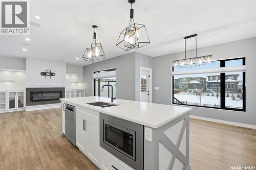 559 Bolstad Turn, Saskatoon, SK - Indoor Photo Showing Kitchen With Fireplace With Double Sink