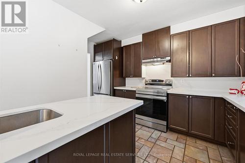 The Gourmet Kitchen Showcases Quartz Countertops - 2299 Wiseman Court, Mississauga, ON - Indoor Photo Showing Kitchen With Stainless Steel Kitchen