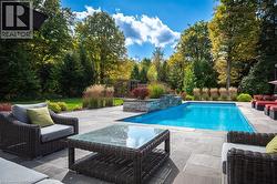 Outdoor pool featuring a patio area and an outdoor living space - 