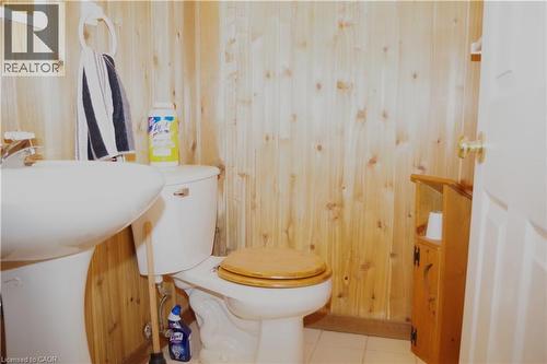 Bathroom featuring wood walls, tile patterned flooring, and vanity - 425 Wellington Street E, Mount Forest, ON - Indoor