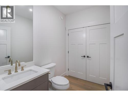 main floor half bath and laundry - 136 Shadow Mountain Boulevard, Cranbrook, BC - Indoor Photo Showing Bathroom