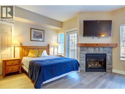 155 Silver Lode Lane Unit# 456, Silver Star, BC - Indoor Photo Showing Bedroom With Fireplace
