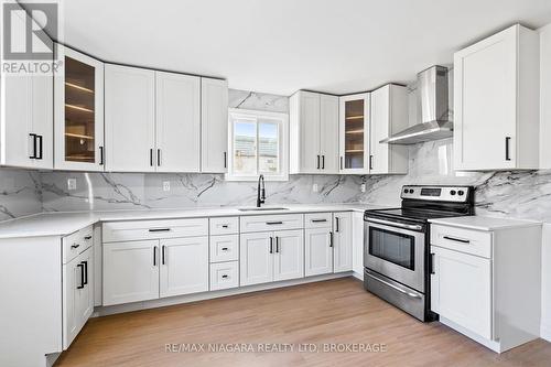 Stone countertops, modern fixtures. - 396 Fairview Road, Fort Erie (Crescent Park), ON - Indoor Photo Showing Kitchen