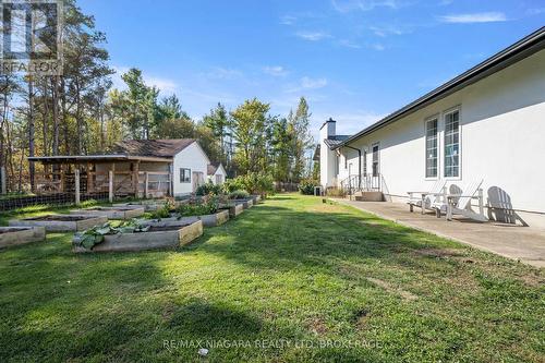 Side yard with two sheds and raised garden beds - 340 Roland Road, Pelham (North Pelham), ON 