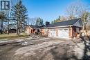 View of front of property with a metal roof, a chimney, brick siding, driveway, and an attached garage - 7087 Rainham Road, Dunnville, ON  - Outdoor 