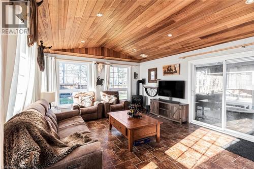 Living room with vaulted ceiling, wood ceiling, stone finish flooring, and recessed lighting - 7087 Rainham Road, Dunnville, ON - Indoor Photo Showing Living Room