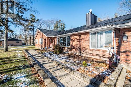 Back of house featuring brick siding, a metal roof, and a chimney - 7087 Rainham Road, Dunnville, ON - Outdoor