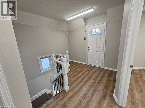 landing at top of stairs with door to upper balcony. - 100 Lancaster Street E, Kitchener, ON 